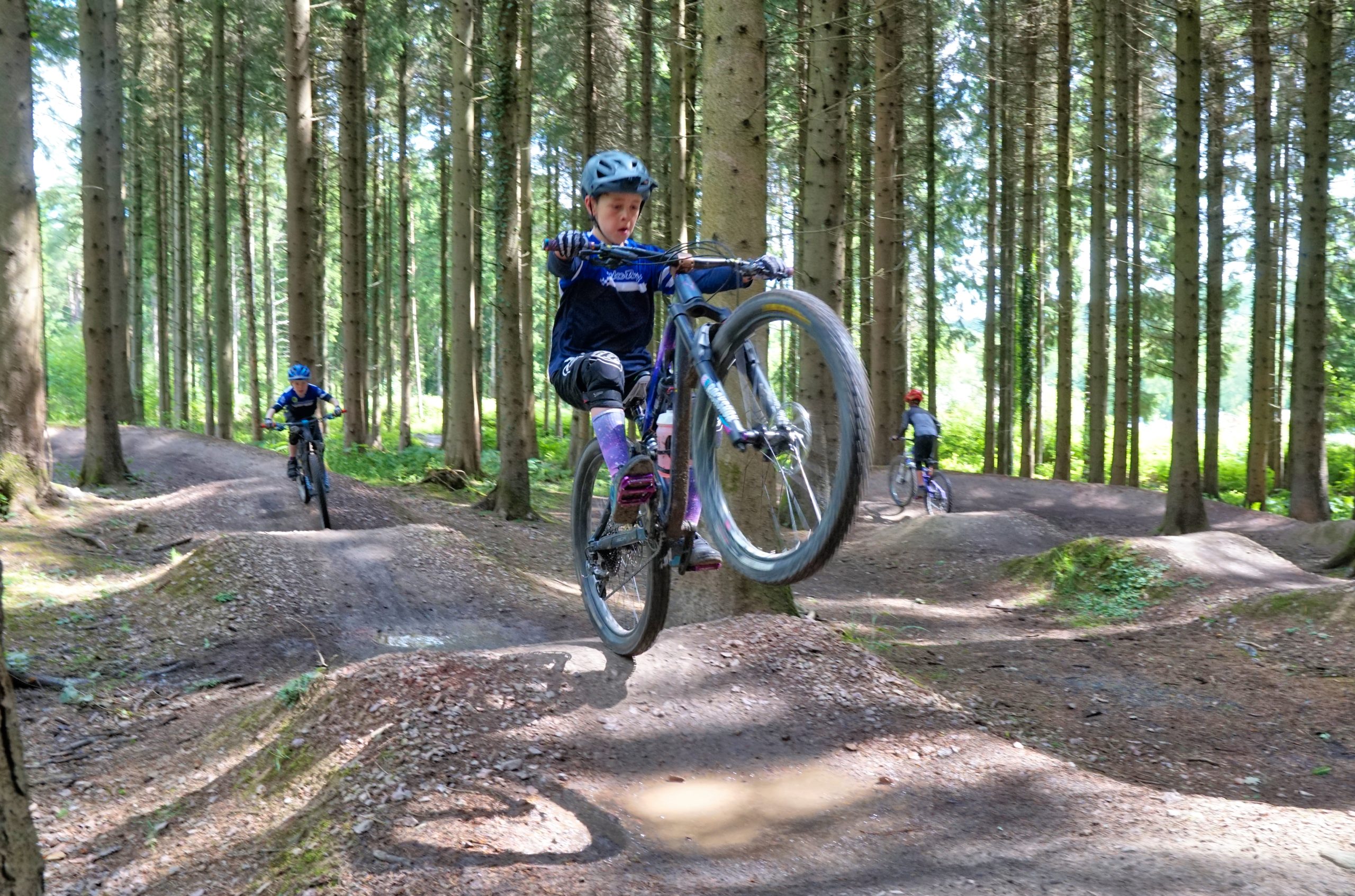Boy in mid air jump at Downhill Youth Development Camps