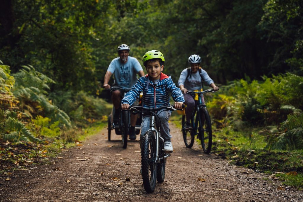 Small boy leading family on the cycle trail.