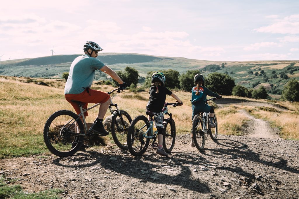 Family at trailhead at Dare Valley Gravity Bike Park.