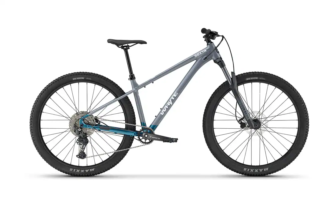 Hire Bike Whyte 529 standard hardtail leaning on blue door.