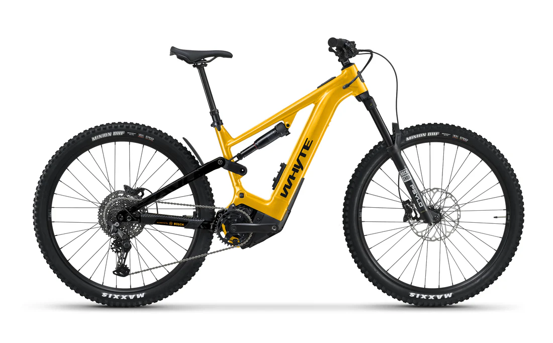 Red Whyte E-160 Full suspension e bike leaning on blue door. 