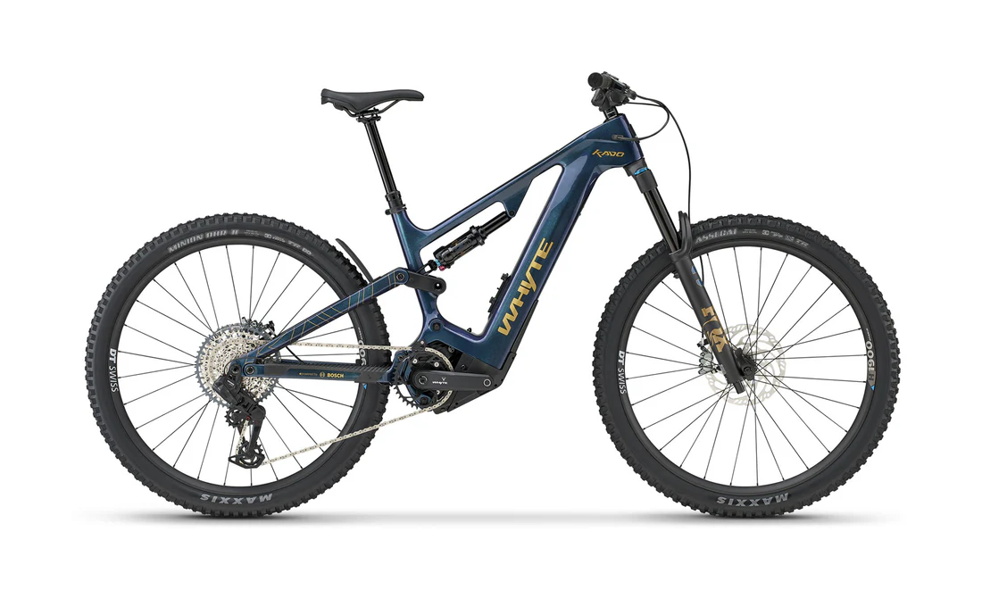 Red Whyte E-160 Full suspension e bike leaning on blue door. 